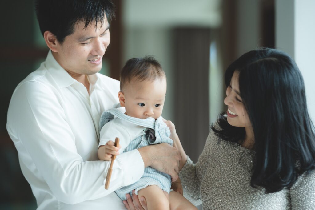 young Asian family are happy together at home by life insurance 
